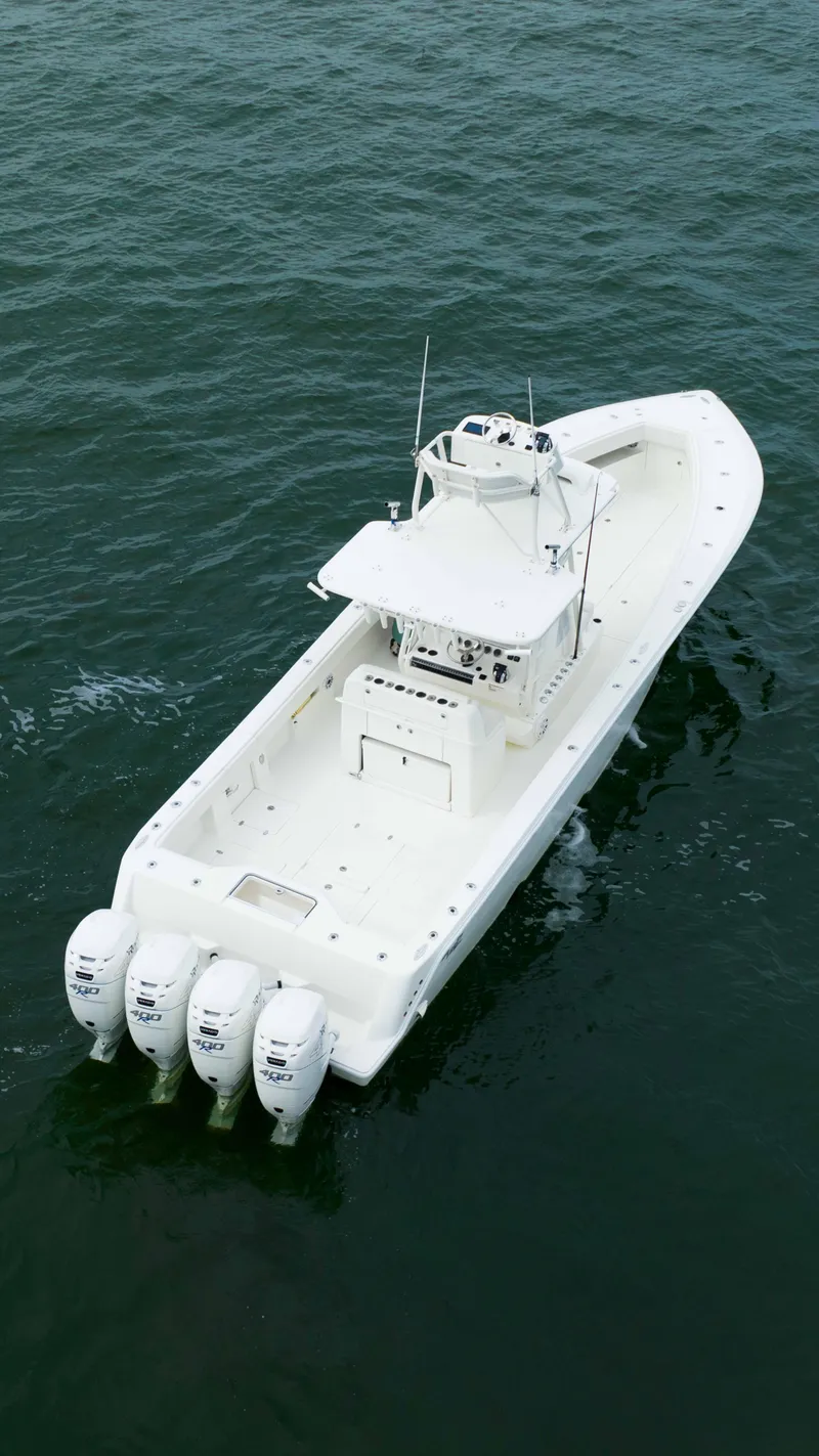 Slide: The Image of 2017 SeaVee 390z Center Console boat with four outboard engines on open water. - 7