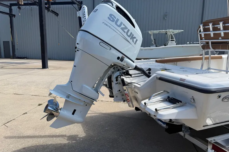 Slide: The Image of 2026 Key West 230 Bay Reef boat with Suzuki outboard motor in a marina setting. - 6