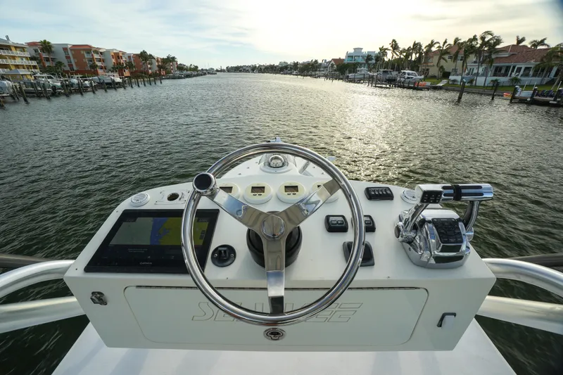 Slide: The Image of Steering console of 2013 SeaVee 390B boat overlooking a scenic waterway. - 11