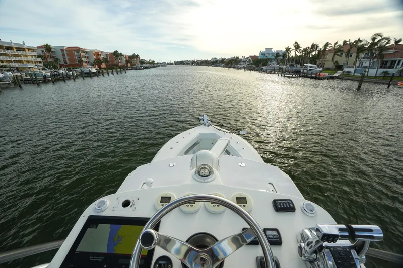 Slide: The Image of 2013 SeaVee 390B boat navigating a scenic waterway at sunset. - 12