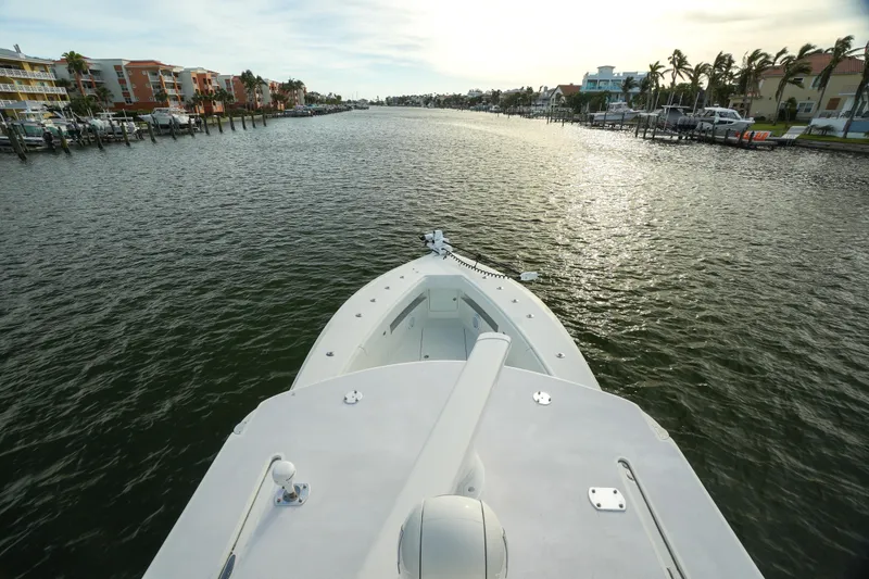 Slide: The Image of SeaVee 390B 2013 boat cruising on a scenic waterway with coastal views. - 13