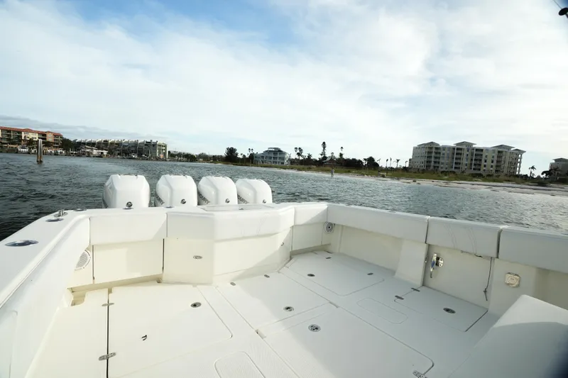 Slide: The Image of 2013 SeaVee 390B boat deck with quad engines, coastal view in background. - 19