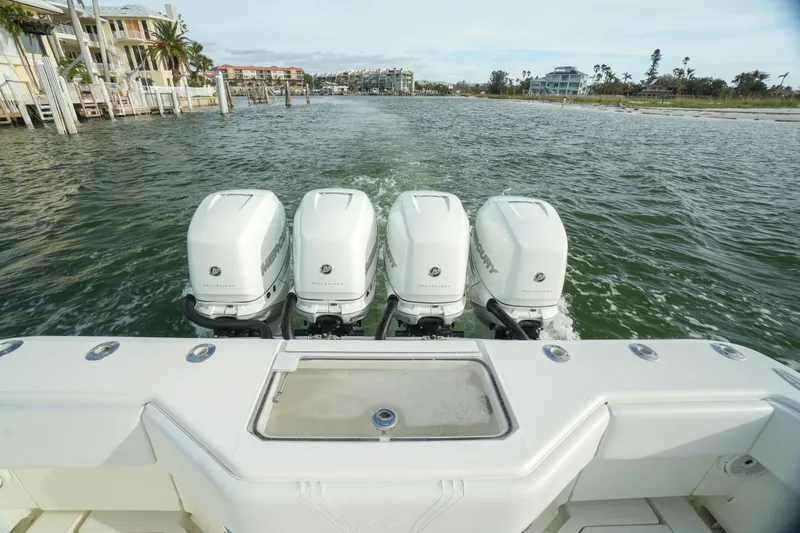 Slide: The Image of 2013 SeaVee 390B boat with four powerful outboard engines on the water. - 20