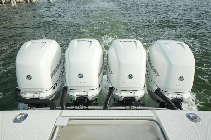 Slide: The Image of Four Mercury outboard engines on a 2013 SeaVee 390B boat in water. - 21