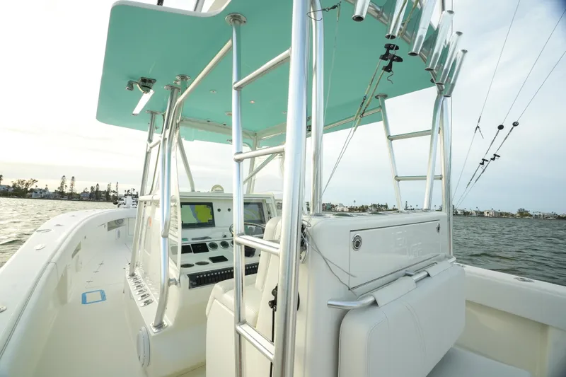 Slide: The Image of 2013 SeaVee 390B boat interior with helm, rod holders, and navigation equipment. - 22