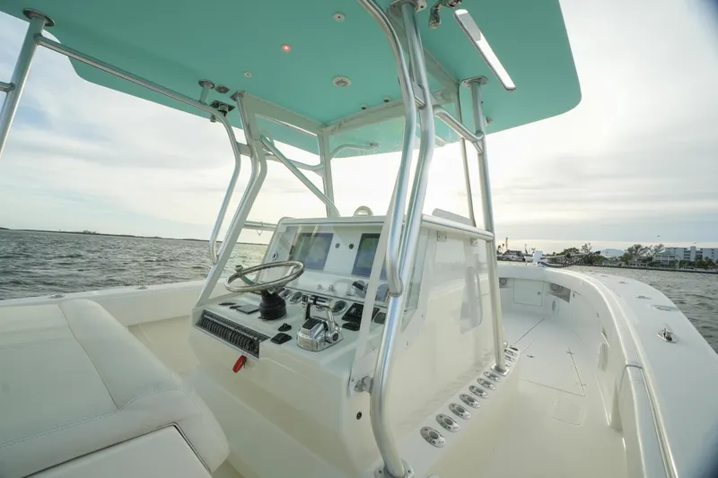 Slide: The Image of SeaVee 390B 2013 boat helm with ocean view, featuring modern controls and seating. - 25