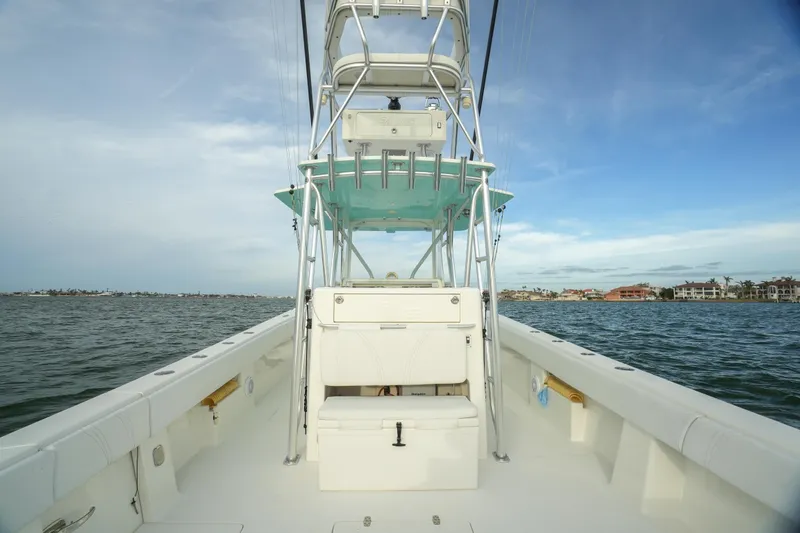 Slide: The Image of 2013 SeaVee 390B boat on open water, featuring a spacious deck and tower. - 27