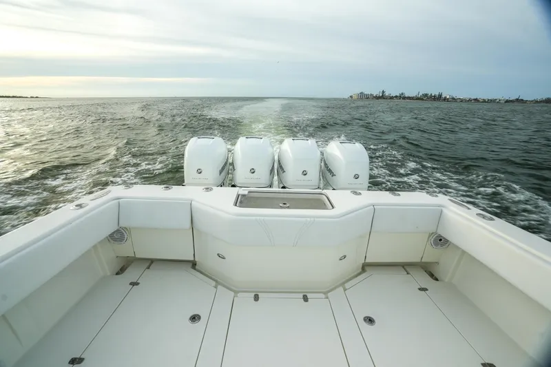 Slide: The Image of 2013 SeaVee 390B boat with four engines cruising on open water. - 29