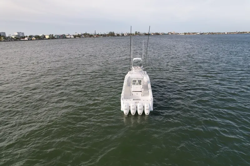 Slide: The Image of SeaVee 390B 2013 boat on open water, rear view with four engines. - 3