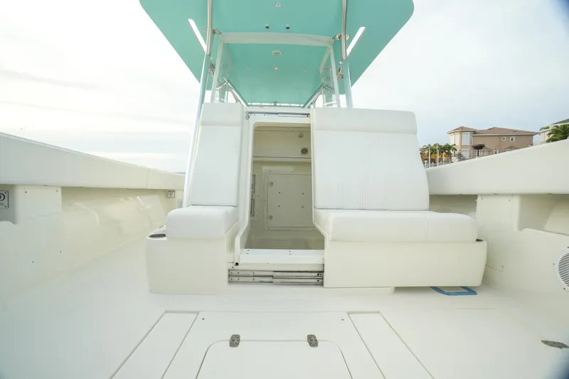 Slide: The Image of 2013 SeaVee 390B boat interior with white seating and teal canopy. - 33