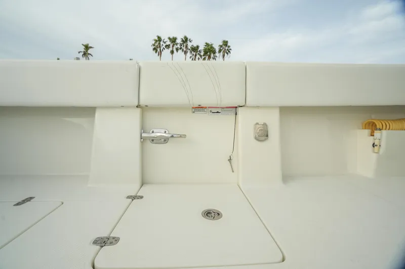 Slide: The Image of 2013 SeaVee 390B boat deck with storage compartments and palm trees in background. - 35