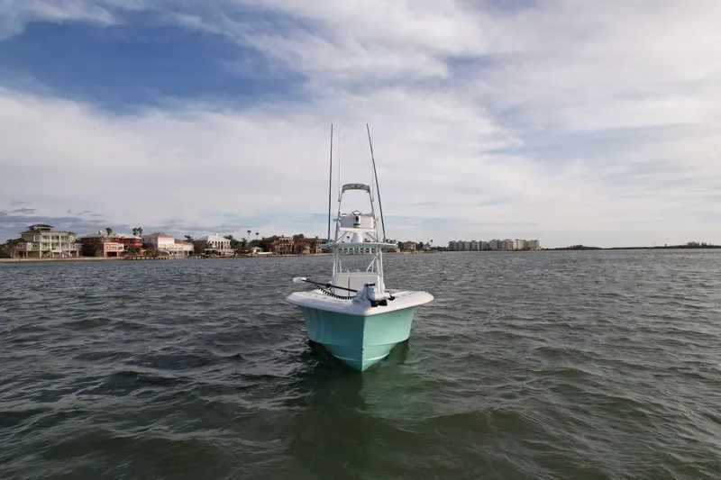 Slide: The Image of 2013 SeaVee 390B boat on open water with coastal background. - 5