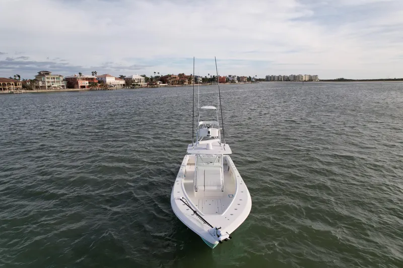 Slide: The Image of 2013 SeaVee 390B boat on open water near coastal homes. - 6