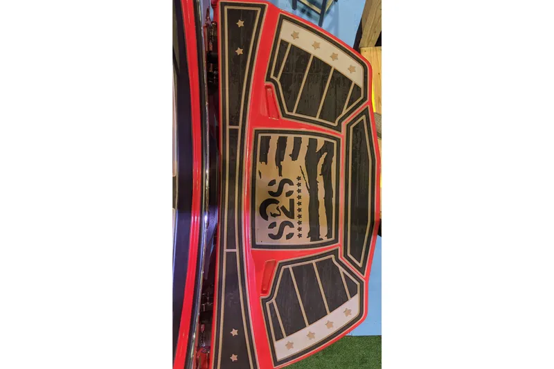 Slide: The Image of 2023 Centurion Ri245 boat deck with red and black design, featuring star accents. - 6