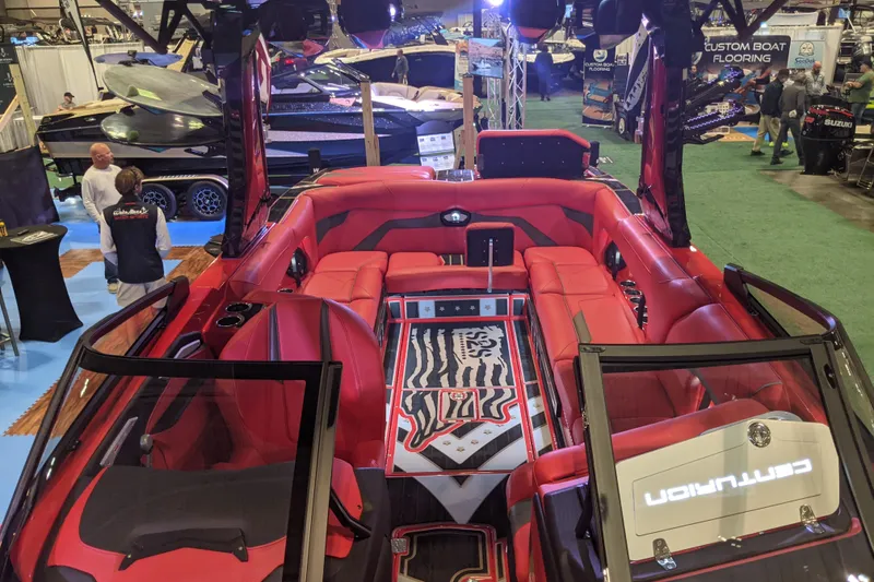Slide: The Image of 2023 Centurion Ri245 boat with luxurious red interior at a boat show display. - 7