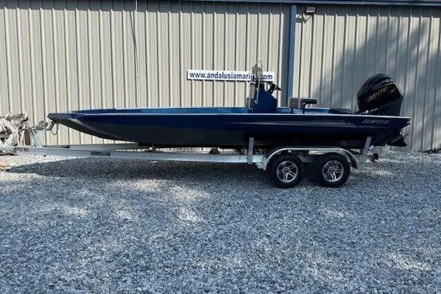 The Image of 2026 Alweld 2270 Vortex boat on trailer, parked on gravel near metal building. - 1