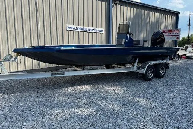 Slide: The Image of 2026 Alweld 2270 Vortex boat on trailer, parked on gravel near a metal building. - 2