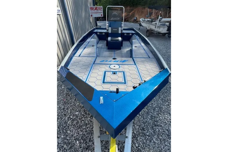 Slide: The Image of 2026 Alweld 2270 Vortex boat with blue deck, parked on gravel. - 8
