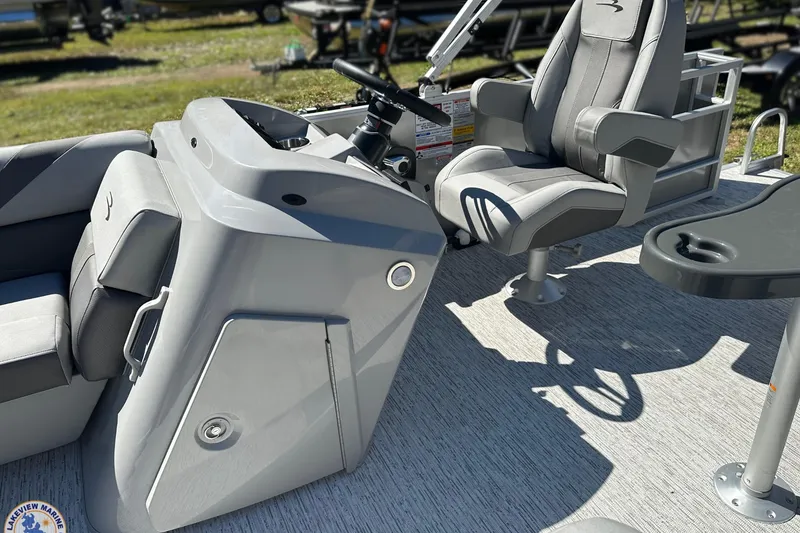 Slide: The Image of 2025 Bennington 18 SXL boat interior with steering console and captain's chair. - 3