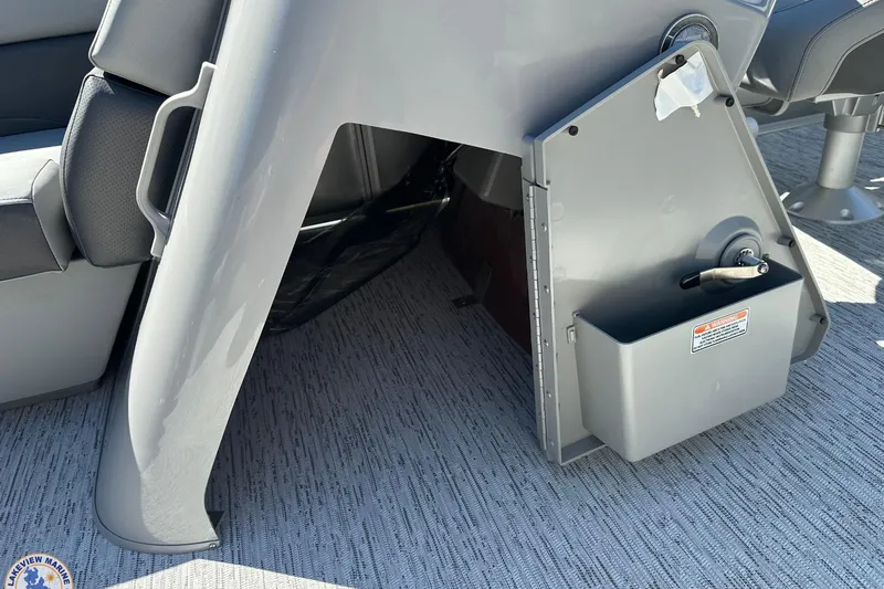 Slide: The Image of 2025 Bennington 18 SXL boat interior with storage compartment and seating. - 7