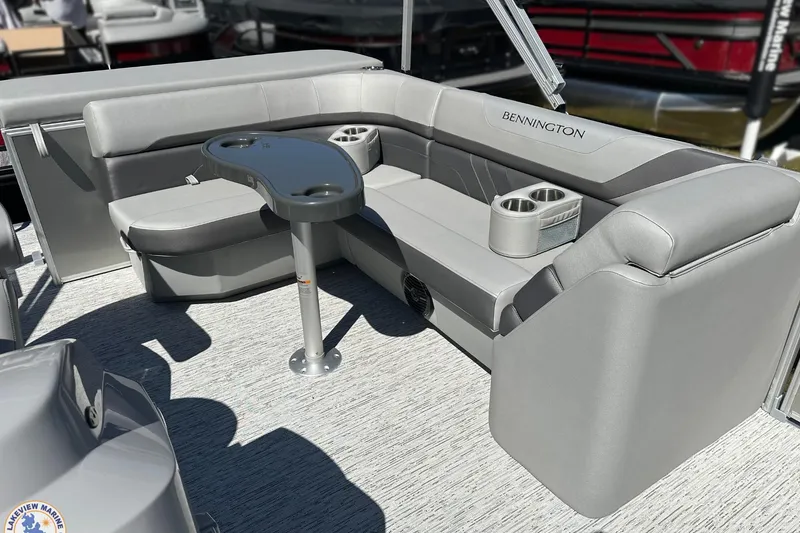Slide: The Image of 2025 Bennington 18 SXL pontoon boat interior with gray seating and cup holders. - 8