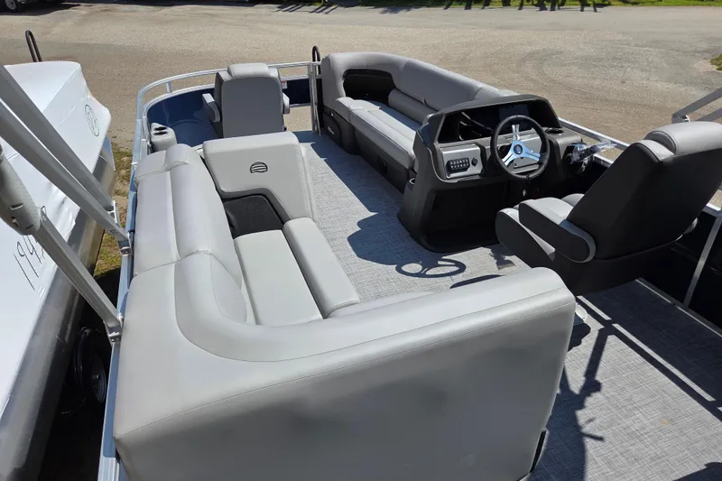 Slide: The Image of 2026 Sun Tracker SportFish 20 DLX pontoon boat interior with gray seating and steering console. - 15