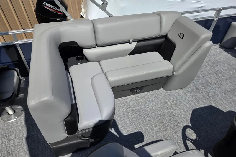 Slide: The Image of 2026 Sun Tracker SportFish 20 DLX boat interior with gray seating and cup holder. - 17