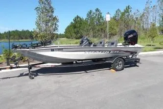 Slide: The Image of 2022 Tracker Pro Team 190 TX Tournament Edition boat on trailer, parked near a lake. - 3