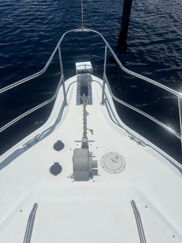 Slide: The Image of Bow of 1996 Sea Ray 400 Sundancer yacht with anchor chain, on calm water. - 12