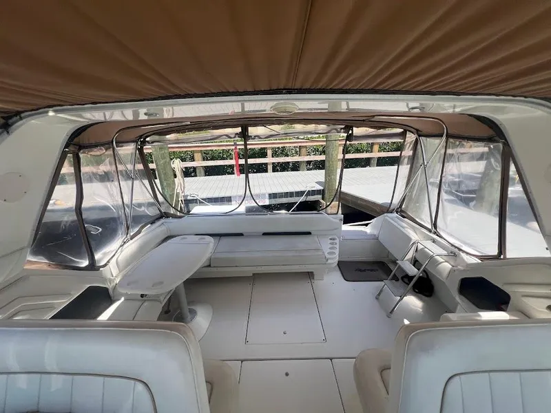 Slide: The Image of Interior of 1996 Sea Ray 400 Sundancer yacht with spacious seating and clear windows. - 7