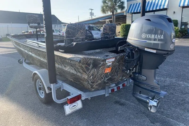 Slide: The Image of 2020 SeaArk RX 170 boat with Yamaha outboard motor on a trailer, parked outdoors. - 1