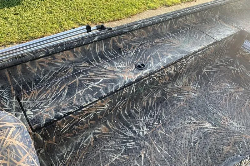 Slide: The Image of 2020 SeaArk RX 170 boat interior with camouflage pattern and storage compartment. - 10