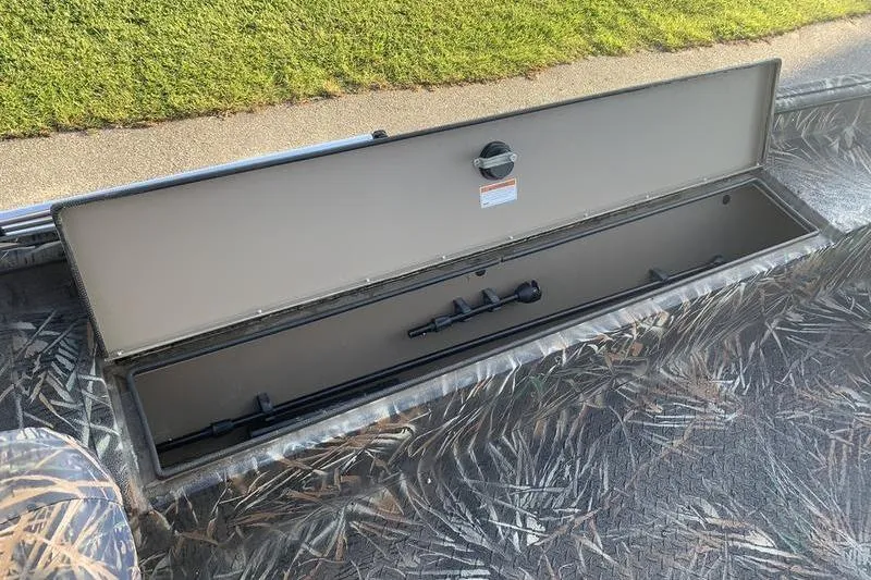 Slide: The Image of Open storage compartment on 2020 SeaArk RX 170 boat, featuring camo design. - 11