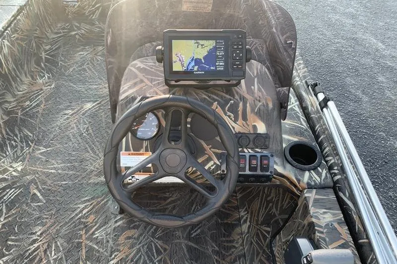 Slide: The Image of 2020 SeaArk RX 170 boat dashboard with GPS, camo design, and steering wheel. - 12