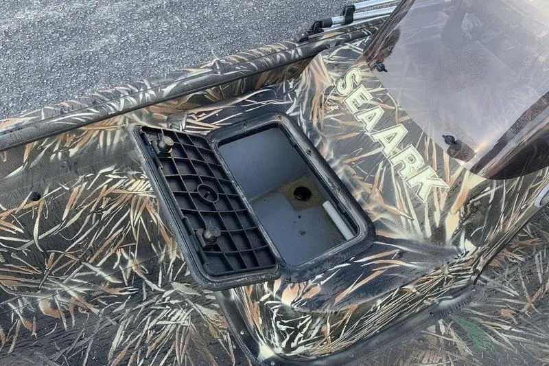 Slide: The Image of 2020 SeaArk RX 170 boat with camouflage design and open storage compartment. - 15