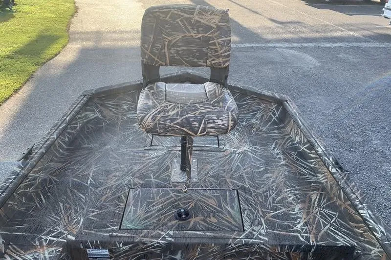 Slide: The Image of 2020 SeaArk RX 170 boat with camo seat and deck, parked on pavement. - 16