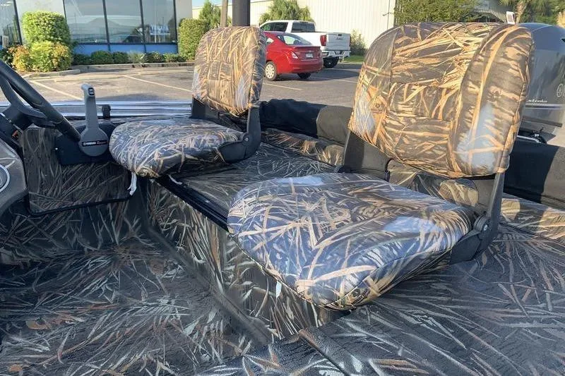 Slide: The Image of 2020 SeaArk RX 170 boat interior with camouflage seats and steering wheel. - 9