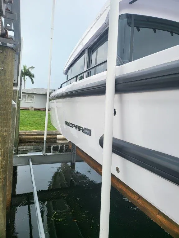 Slide: The Image of 2024 Axopar 37 XC CROSS CABIN boat docked, side view. - 10