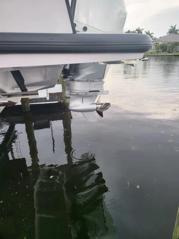 Slide: The Image of 2024 Axopar 37 XC CROSS CABIN motorboat stern in calm water. - 8