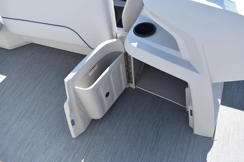 Slide: The Image of Open storage compartment on 2026 Godfrey Sweetwater 2086 C boat, featuring cup holder. - 11