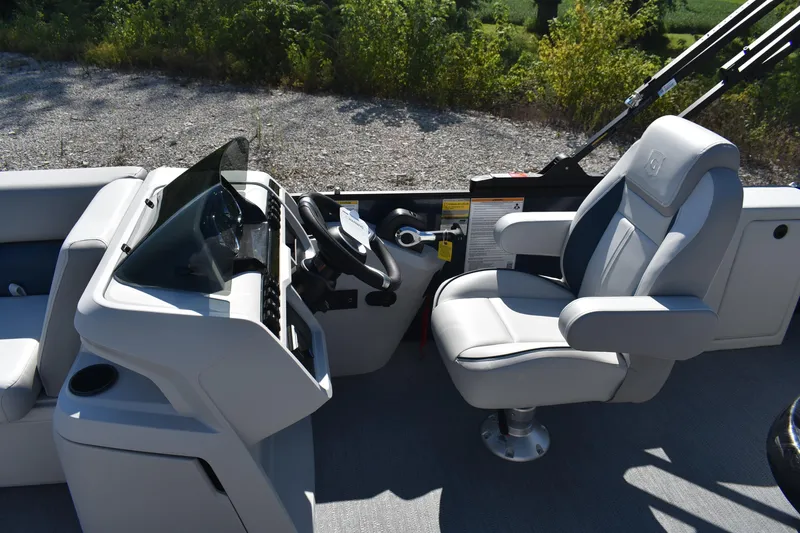 Slide: The Image of 2026 Godfrey Sweetwater 2086 C boat interior with captain's chair and control console. - 16