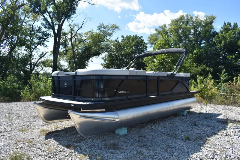 Slide: The Image of 2026 Godfrey Sweetwater 2086 C pontoon boat on gravel, surrounded by trees. - 3