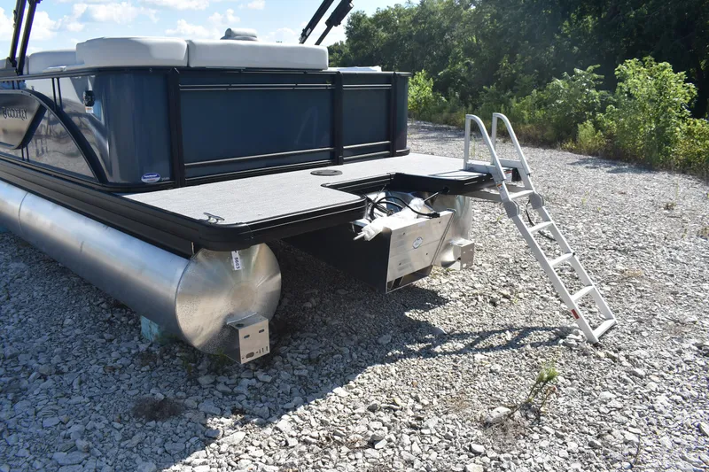 Slide: The Image of 2026 Godfrey Sweetwater 2086 C pontoon boat with ladder on gravel surface. - 7
