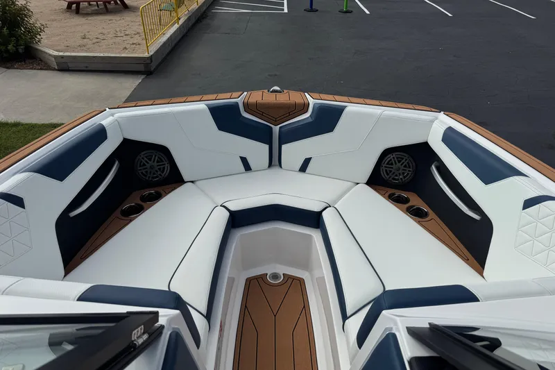 Slide: The Image of 2026 Nautique Super Air Nautique GS22 boat interior with white and blue seating. - 10