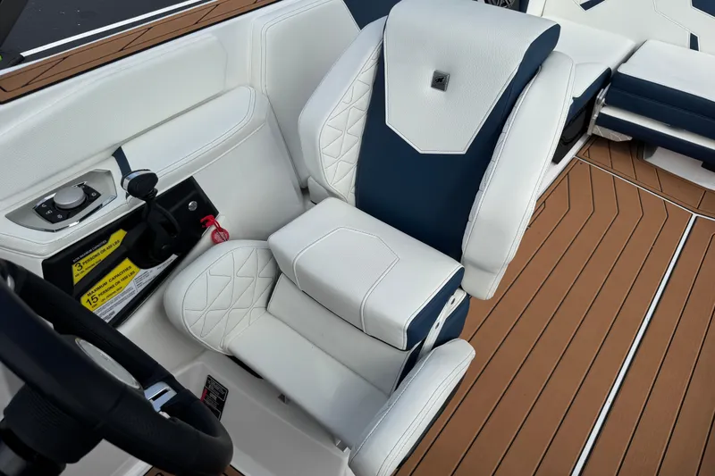 Slide: The Image of 2026 Nautique Super Air Nautique GS22 cockpit with luxurious white and blue seating. - 17