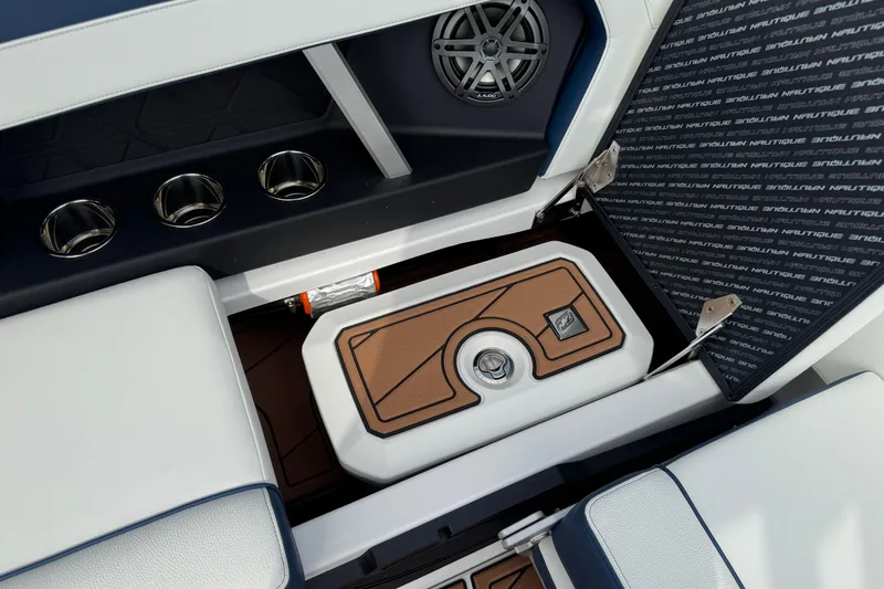 Slide: The Image of 2026 Nautique Super Air Nautique GS22 interior with storage compartment and cup holders. - 21
