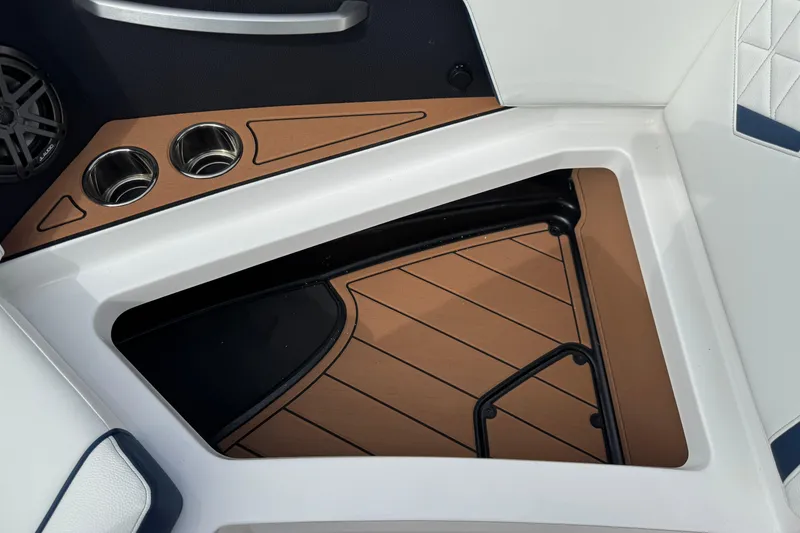 Slide: The Image of 2026 Nautique Super Air Nautique GS22 interior with cup holders and speaker detail. - 27