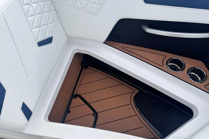 Slide: The Image of 2026 Nautique Super Air Nautique GS22 interior with white upholstery and wood accents. - 28