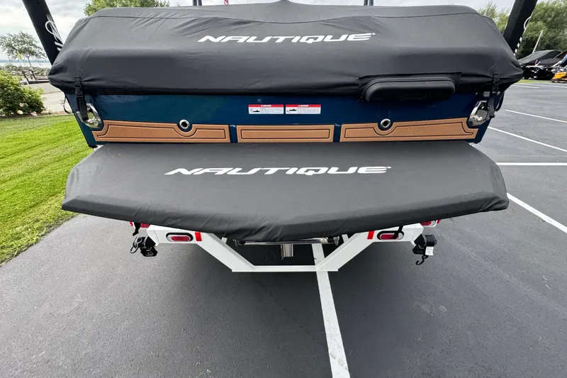 Slide: The Image of 2026 Nautique Super Air Nautique GS22 boat rear view with cover in parking lot. - 32
