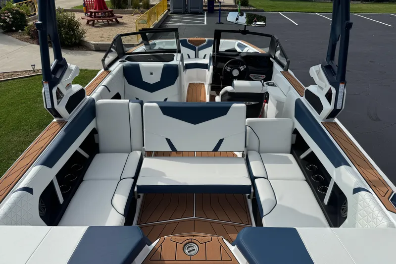 Slide: The Image of 2026 Nautique Super Air Nautique GS22 interior with white and blue seating, wood accents. - 8